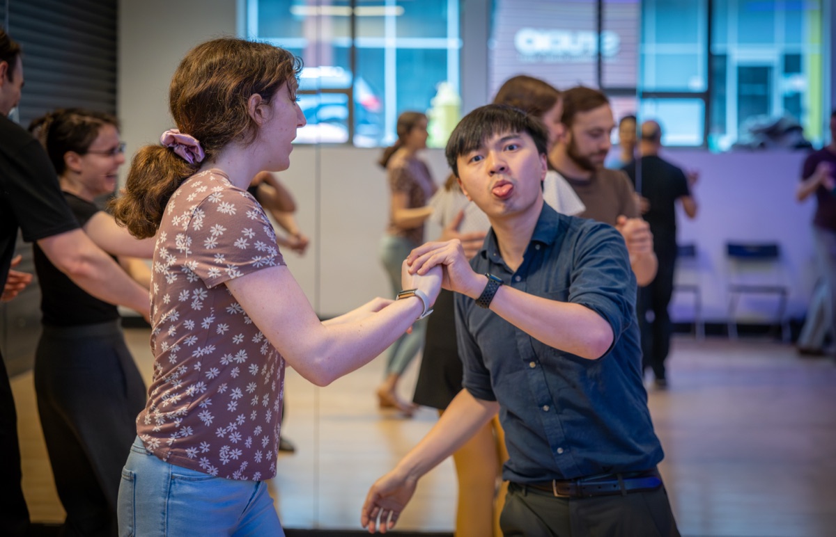 Kang Kang dancing Lindy Hop with a partner at a social